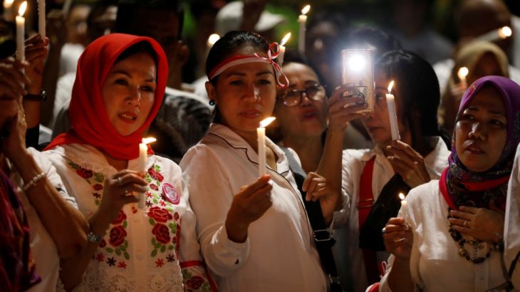 People attend a candlelight ceremony in support of the victims and victims'' families of the recent attacks at police stations and churches in Jakarta and Surabaya, in a park in Jakarta
