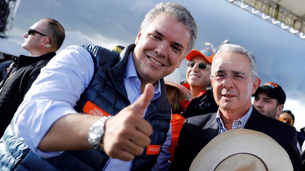 Duque's, left, close relationship with Uribe, right, has boosted support for his candidacy [Nacho Doce/ Reuters]