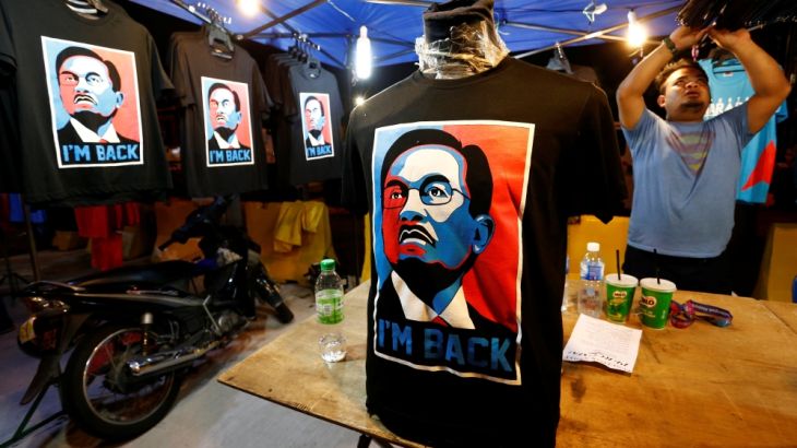 T-shirts bearing likeness of Malaysian politician Anwar Ibrahim, who was granted a royal pardon, are displayed at a rally which Anwar was to attend in Kuala Lumpur