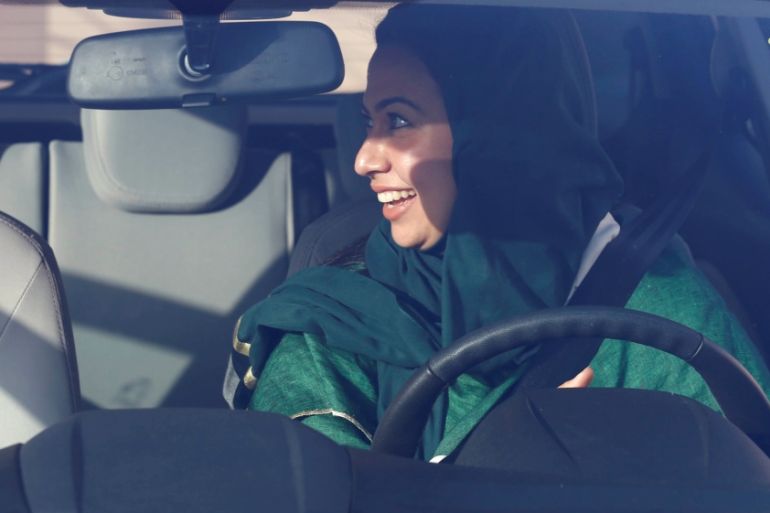 Saudi woman sits in a car during a driving training at a university in Jeddah