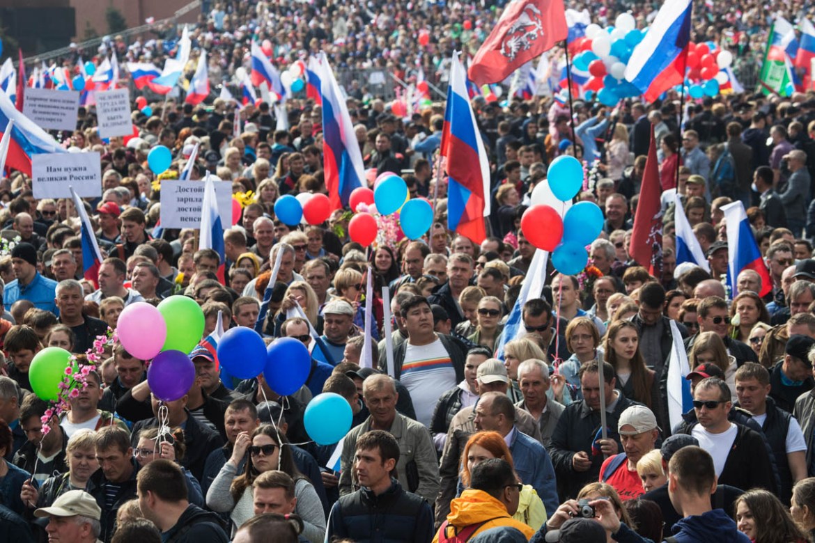 Balloons and flags fly over the crowd as people walk on Red Square to mark May Day in Moscow, Russia, Tuesday, May 1, 2018. As in Soviet times, people paraded across Red Square, but instead of red fla