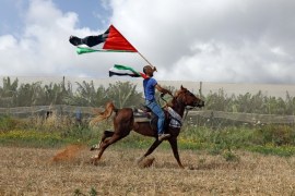 A man rides a horse during a rally of Israeli Arabs calling for the right of return for refugees who fled their homes during the 1948 Arab-Israeli War, near Atlit