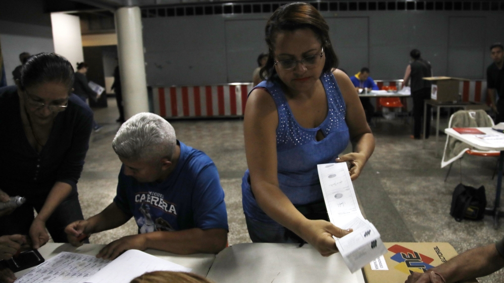 Electoral workers count ballots at a polling station in Caracas, Venezuela [Adriana Loureiro/Reuters]