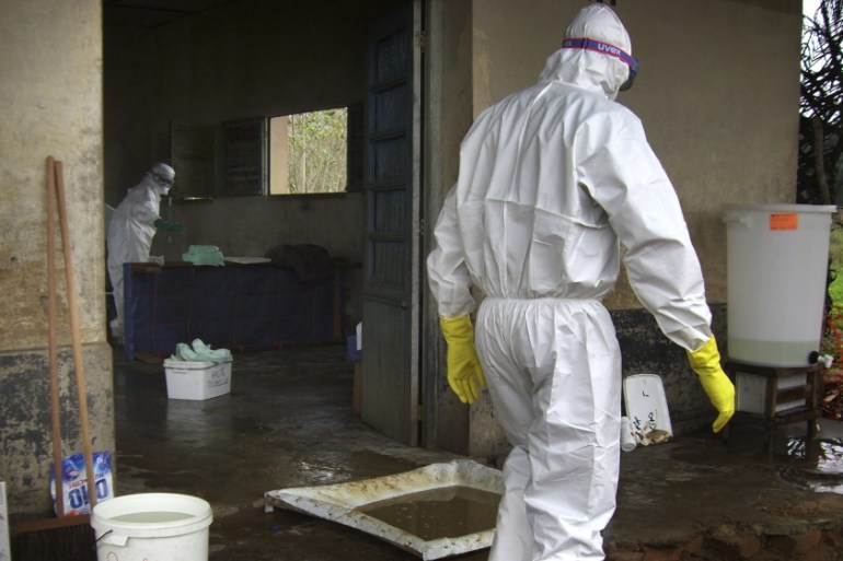 Medical workers in protective clothings work in the Ebola isolation zone at the village of Kampungu, DRC [Frederic Patign