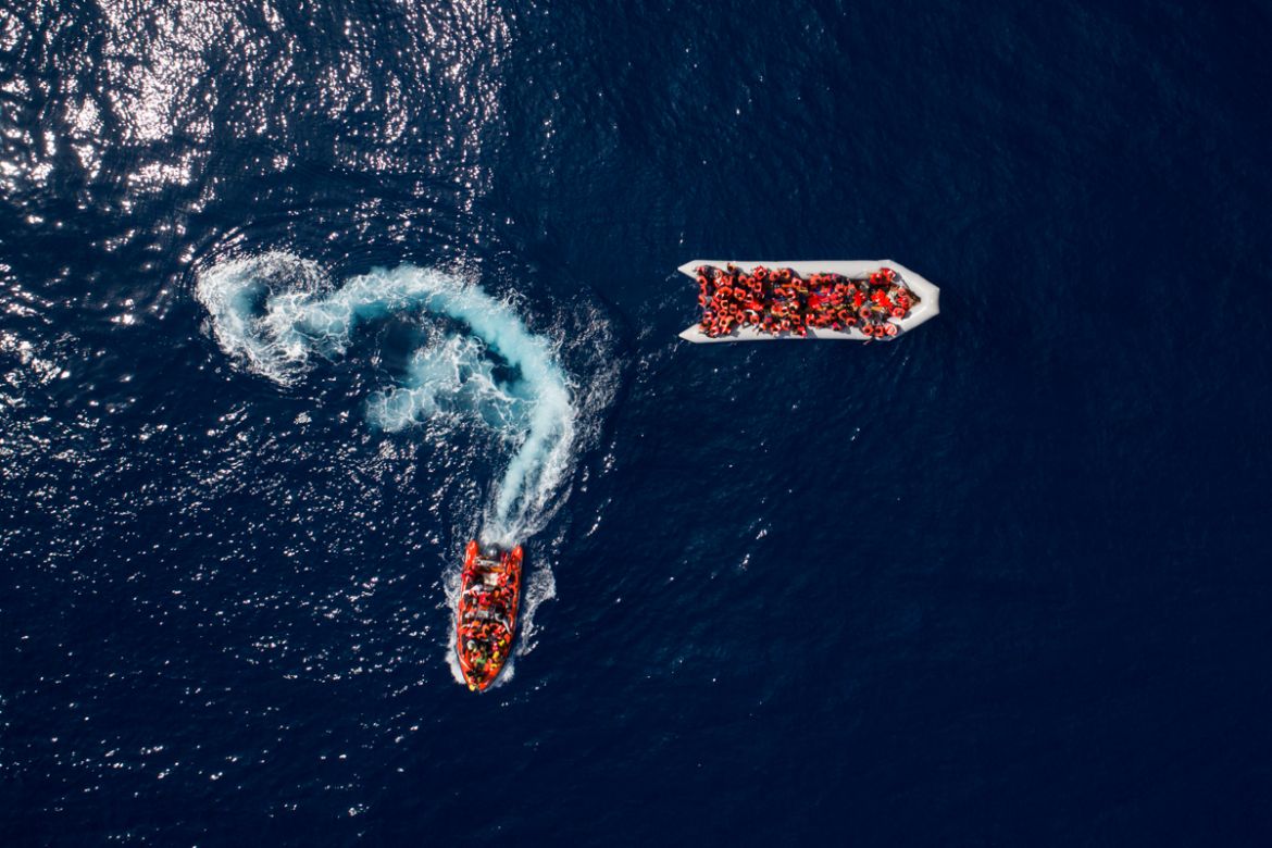 Refugees and migrants are rescued by members of the Spanish NGO Proactiva Open Arms, after leaving Libya trying to reach European soil aboard an overcrowded rubber boat, north of Libyan coast, Sunday,