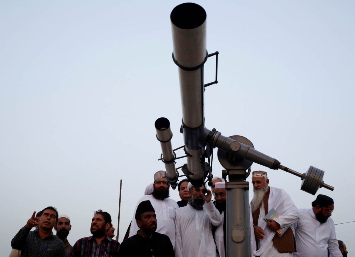 Members of the moon sighting committee gather and use telescope for the new moon that will mark the start of Ramadan, from Pakistan''s Meteorological Department (PMD) building in Karachi, Pakistan May
