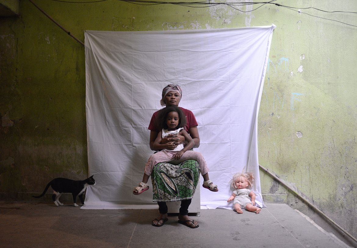A mother and her child, both refugees from the Democratic Republic of Congo, are pictured in the Ramos favela in Rio de Janeiro. Single mothers, who are often fleeing sexual abuse, suffer greatly, wit