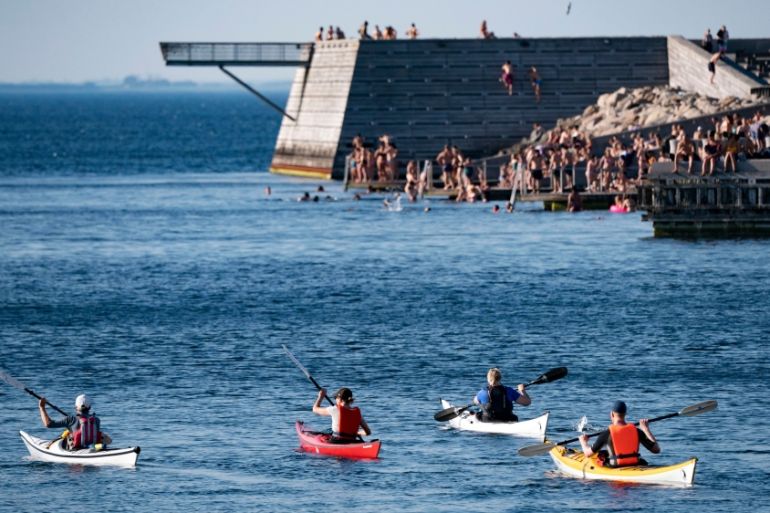 People enjoy the cooling water in Malmo, southern Sweden