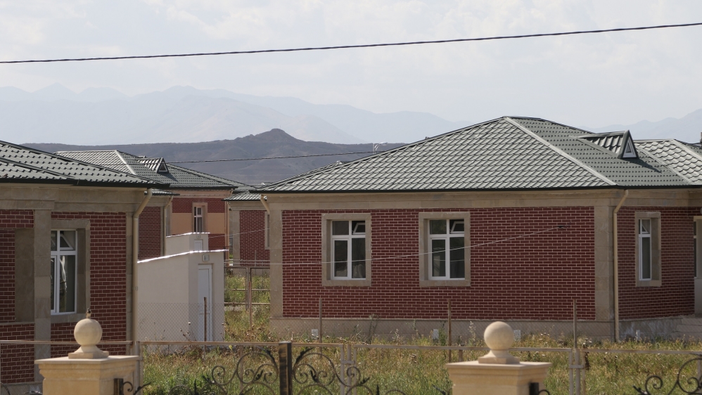New houses in Jojug Marjanli. Mountains occupied by separatists can be seen in the distance [Gurban Bakirov/Al Jazeera] 