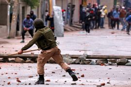 Demonstrators throw stones towards the Indian police during a protest against the recent killings in Kashmir, in Srinagar May 8, 2018. [Danish Ismail/Reuters]