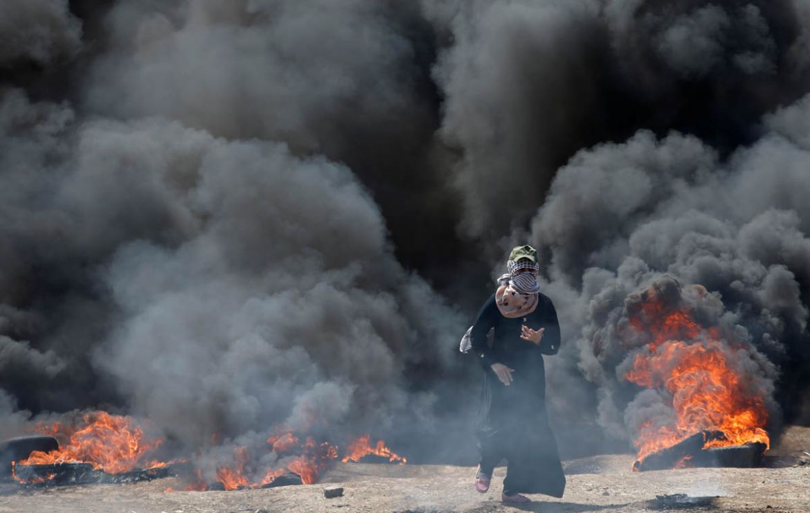 A female Palestinian demonstrator gestures during a protest against U.S. embassy move to Jerusalem and ahead of the 70th anniversary of Nakba, at the Israel-Gaza border, east of Gaza City May 14, 2018