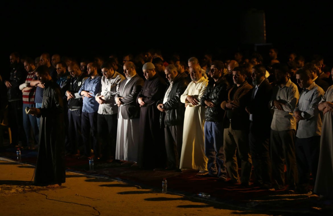 Palestinians perform an evening prayer called ''tarawih'' marking the first eve of the holy fasting month of Ramadan, outside the tents of the protest camp near the Israeli border east of Gaza City, Wed