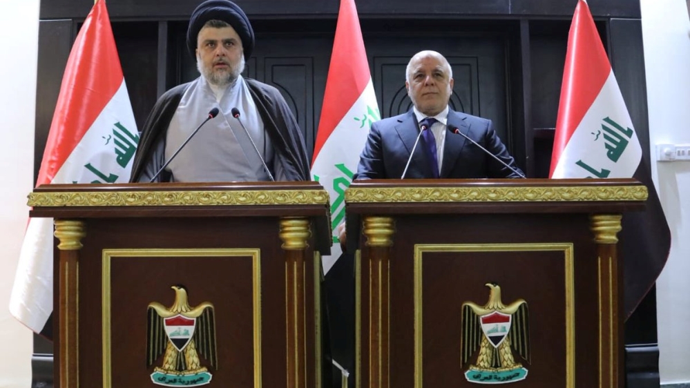 Al-Sadr (L) and al-Abadi (R) addressed reporters after their meeting [Iraqi prime minister media office via Reuters]