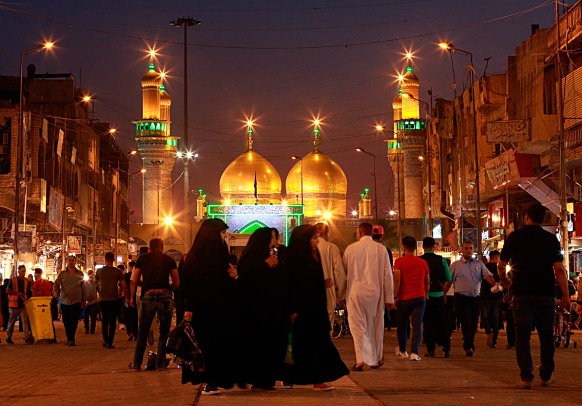 Shia worshippers gather near the golden-domed shrine of Imam Moussa al-Kadhim, in the background, to mark the beginning of Ramadan in Baghdad, Iraq, Wednesday, May 16, 2018. Muslims throughout the wor