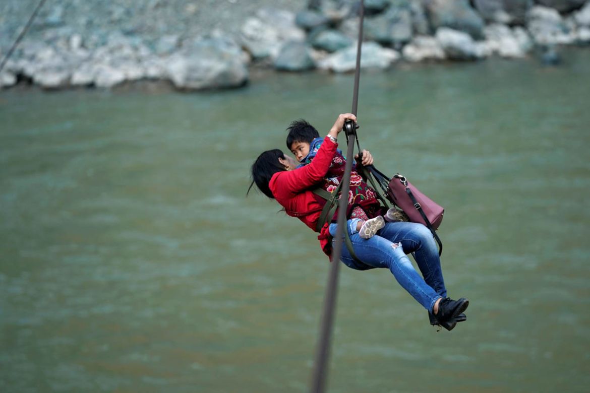 Cha Huilan, a 40-year old Lisu woman, and her daughter leave Lazimi village with a zipline across the Nu River in Nujiang Lisu Autonomous Prefecture in Yunnan province, China, March 24, 2018. Picture