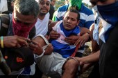 Demonstrators help an injured protester during clashes with riot police during a protest against President Daniel Ortega's government in Managua, Nicaragua on May 30, 2018 [Oswaldo Rivas/Reuters]