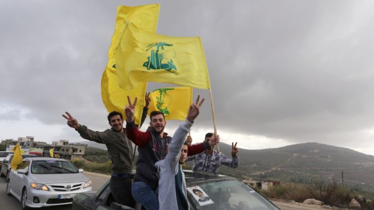 Supporters of Lebanon''s Hezbollah leader Sayyed Hassan Nasrallah gesture as they hold Hezbollah flags in Marjayoun, Lebanon May 7, 2018. [Aziz Taher/Reuters]
