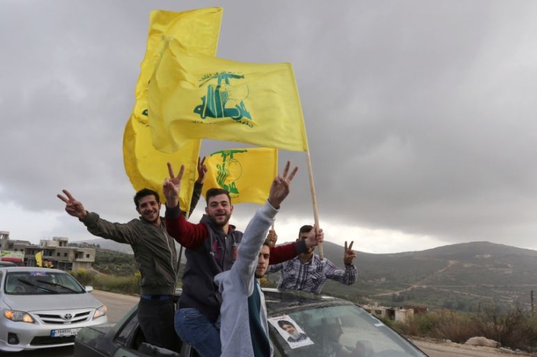 Supporters of Lebanon''s Hezbollah leader Sayyed Hassan Nasrallah gesture as they hold Hezbollah flags in Marjayoun, Lebanon May 7, 2018. [Aziz Taher/Reuters]