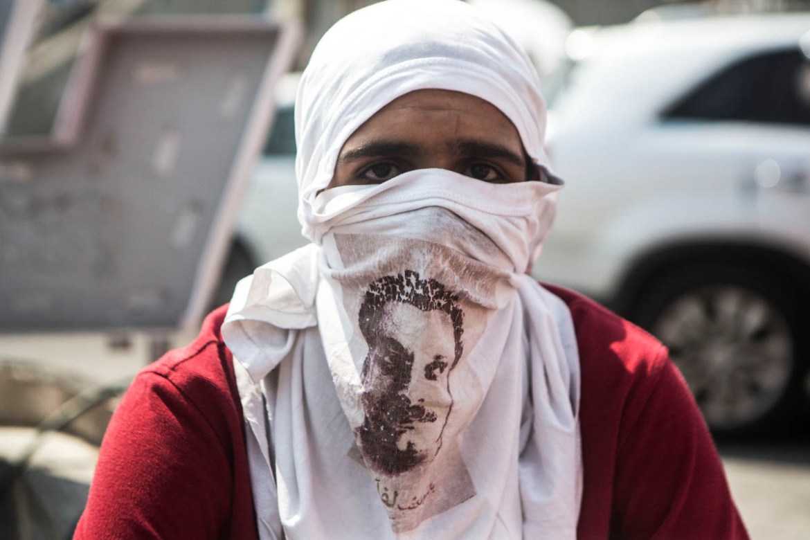 A Palestinian youth covers his face with a Tshirt with the portrait of Palestinian author Ghassan Kanafani and a leading member of the Popular Front for the Liberation of Palestine (PFLP). Many Pales