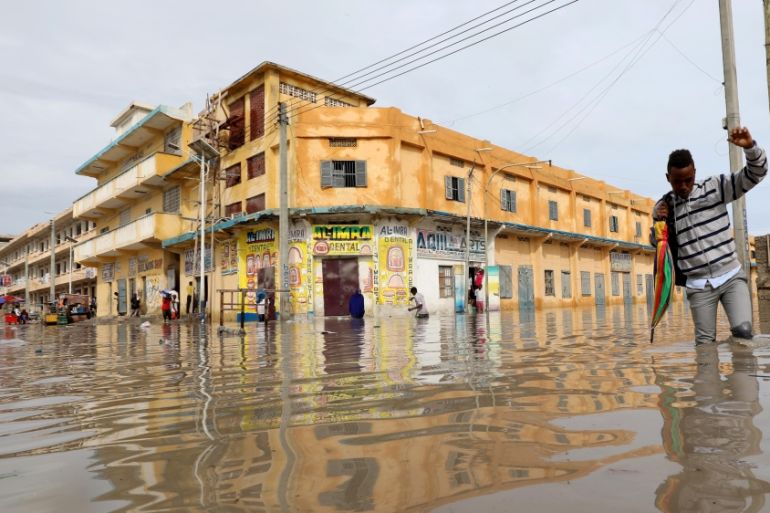 A man wades through a flooded street in Hamerweyne district of Mogadishu