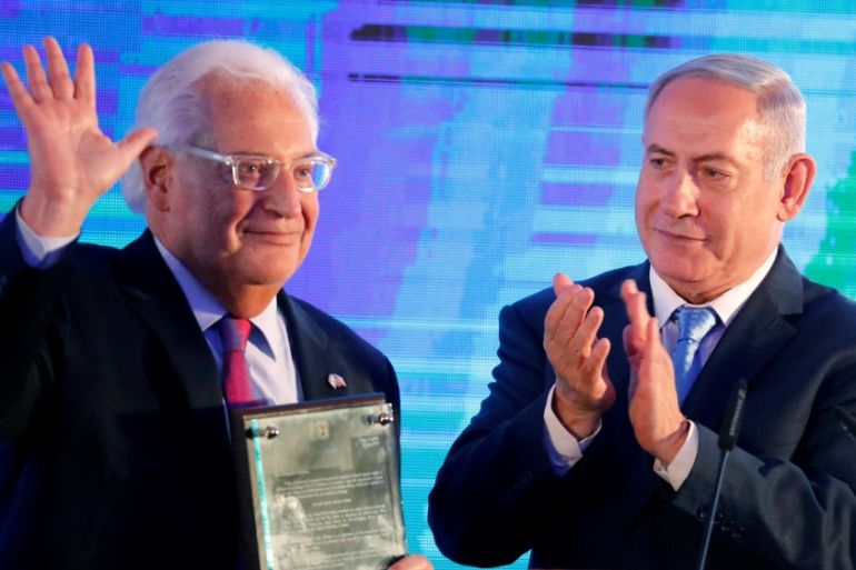 Israeli Prime Minister Benjamin Netanyahu claps after handing