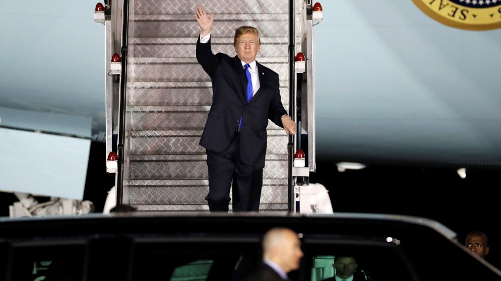 Trump waves as he steps off his plane upon arriving in Singapore [Kim Kyung-hoon/Reuters]