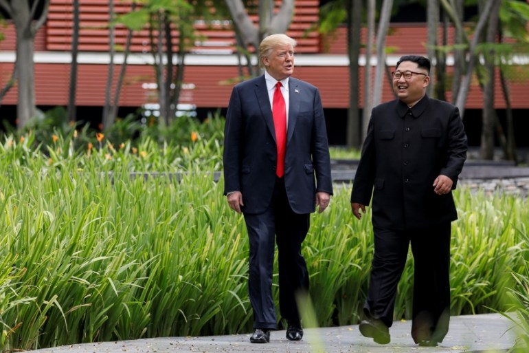 U.S. President Trump and North Korea''s Kim walk together before their working lunch during their summit in Singapore