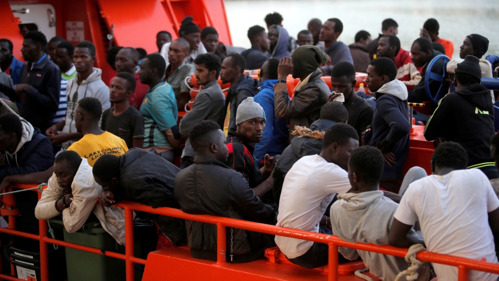 Migrants, part of a group intercepted on board dinghies off the coast in the Mediterranean Sea, are seen on a rescue boat upon arrival at the port of Malaga, Spain June 23, 2018 [Jon Nazca/Reuters]