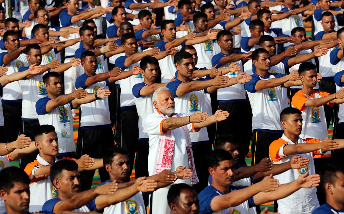 Indian Prime Minister Narendra Modi, center, performs yoga along with thousands of Indians to mark International Day of Yoga in Dehradun, India, Thursday, June 21, 2018. Millions of yoga enthusiasts a