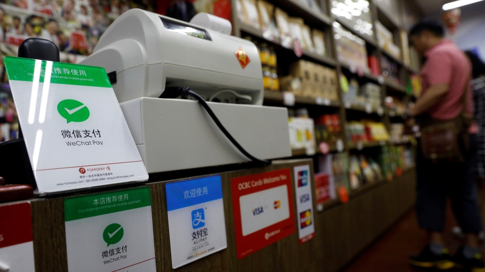 Signs accepting WeChat Pay and AliPay are displayed at a shop in Singapore on May 22, 2018 [Edgar Su/Reuters]