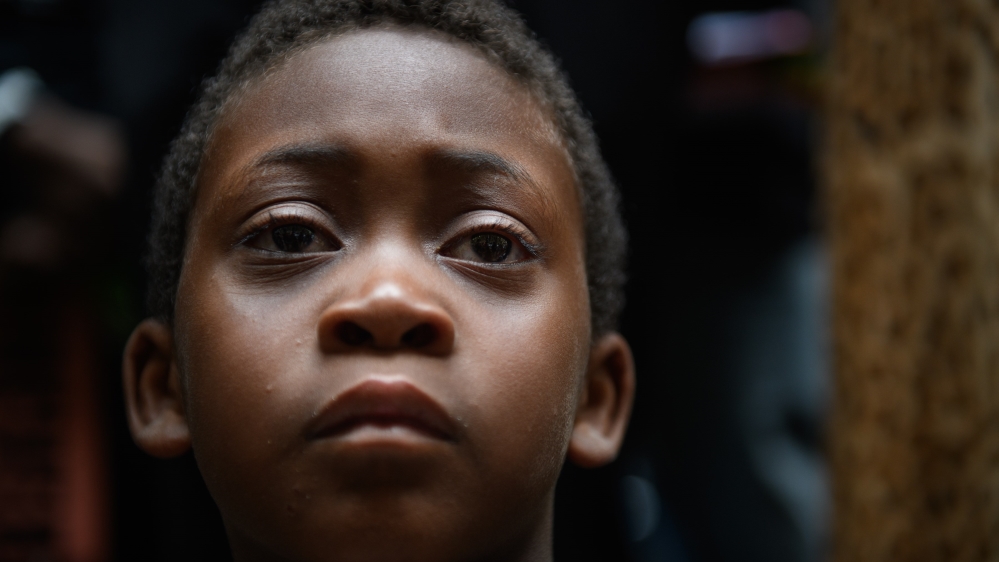 Jeremiah Rooke, 7, listens during a rally by more than 200 people protesting the fatal police shooting of Antwon Rose [Justin Merriman/Getty Images/AFP]