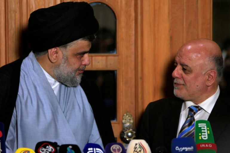 Iraqi Shi''ite cleric Moqtada al-Sadr, who''s bloc came first, looks at Iraqi Prime Minister Haider al-Abadi, who''s political bloc came third in a May parliamentary election
