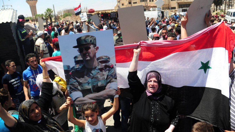 An image by Syrian state media showing people celebrating the army's arrival in Dael town [SANA handout via Reuters] 