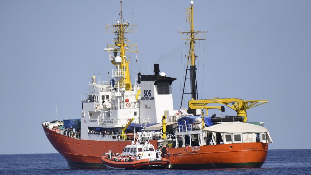 An Italian coastguard boat approaches the Aquarius ship [Salvatore Cavalli/The Associated Press]