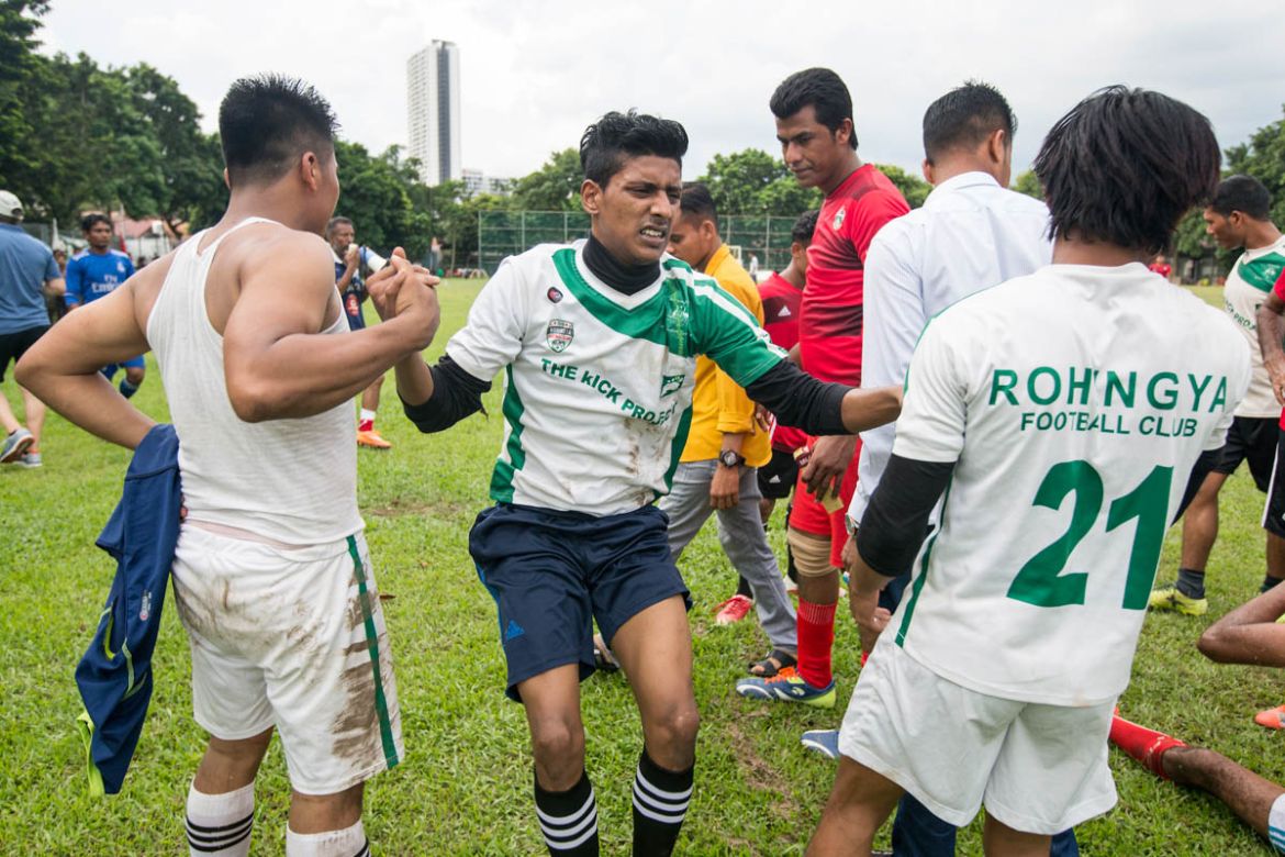 Farouk Yusuf (C), 22, one of RFC''s defenders, is lifted by his teammates after being injured during the match. Farouk trains to be a professional football player. He was born in Malaysia and went to a
