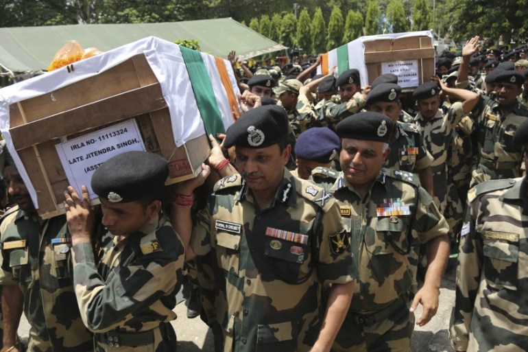 Indian Border Security Force (BSF) officers carry the coffins of four of their colleagues who were killed early Wednesday during a wreath-laying ceremony at the BSF headquarters in Jammu, India, Wedne