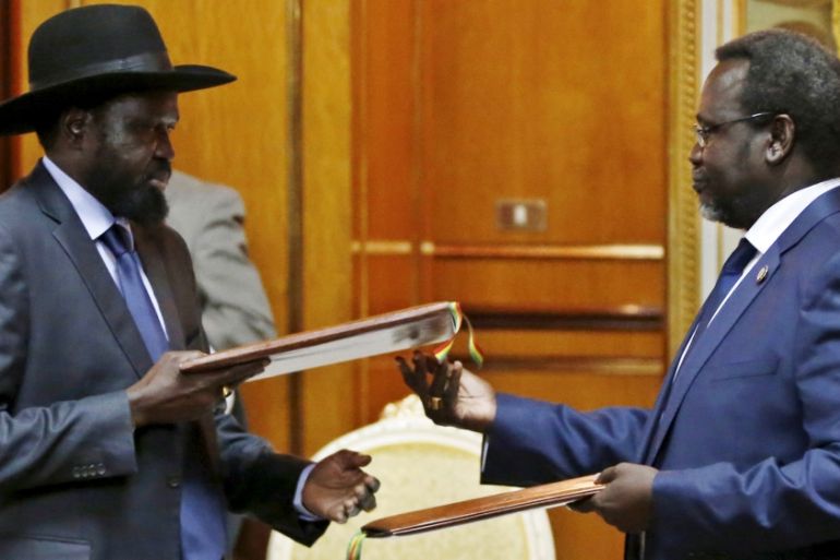 File photo shows South Sudan''s rebel leader Riek Machar and South Sudan''s President Salva Kiir exchanging signed peace agreement documents in Addis Ababa