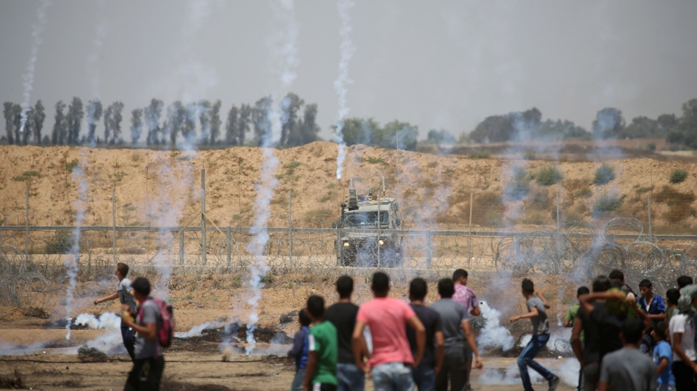 Teargas fired by Israeli troops at Palestinian demonstrators during a protest marking Jerusalem Day [Ibraheem Abu Mustafa/Reuters]