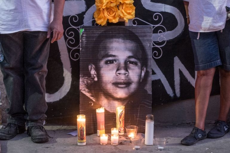 Candles and a picture of José Rodriguez during a vigil. [Eline van Nes/Al Jazeera]