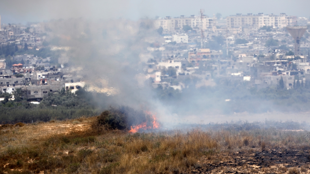 A fire burns in scrubland in Israel near the Gaza Strip; Palestinians have been flying kites and balloons loaded with flammable material across the border between Israel and Gaza [Amir Cohen/Reuters]