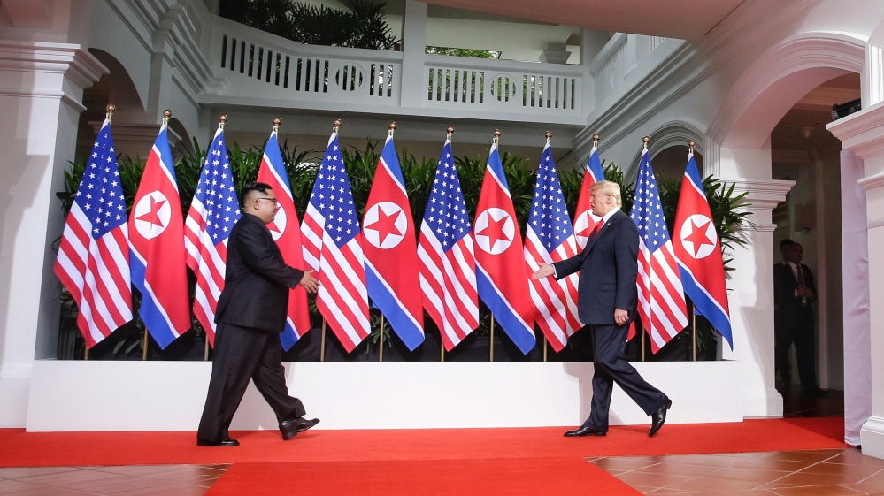 Kim and Trump moments before their historic handshake [File: Kevin Lim/The Straits Times]