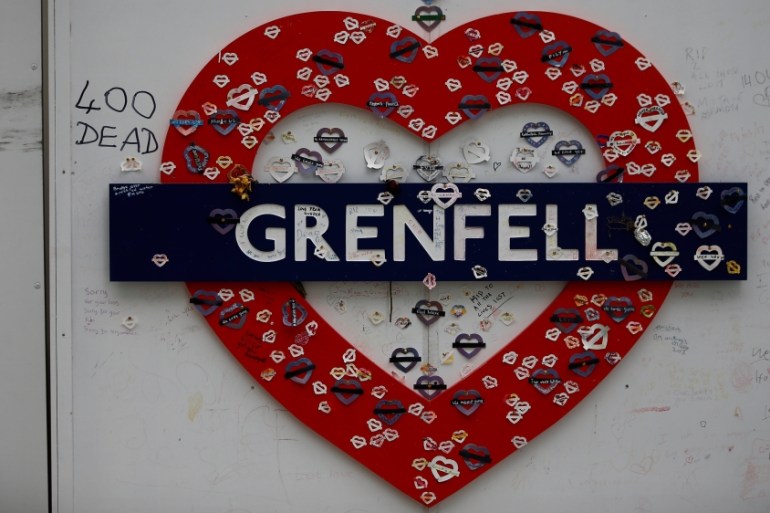 A tribute hangs from a hoarding surrounding Grenfell Tower