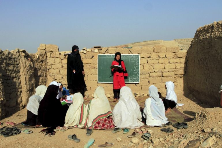 Afghan girls study at an open area,