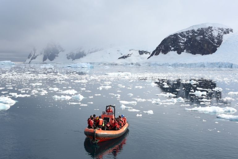 A Greenpeace boat floats in Neko Harbour, Antarctica