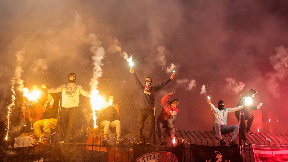 Russian football fans of Spartak Moscow burn flares during a national league match [Denis Tyrin/AP]