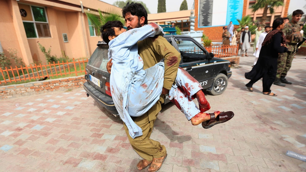 Wounded men were carried to a hospital after a car bombing in Jalalabad on June 17 [Parwiz/Reuters]