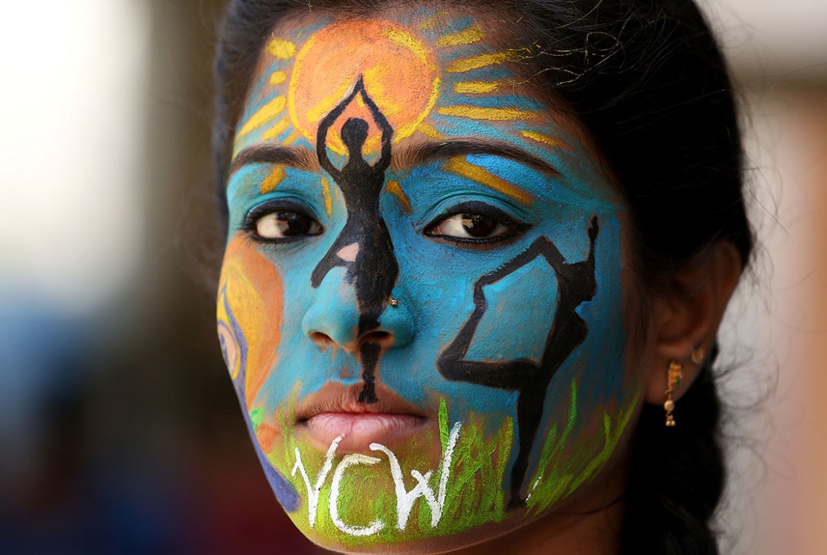 A college student poses as she displays her painted face as an awareness ahead of International Yoga Day, in Chennai, India June 20, 2018. REUTERS/P.Ravikumar