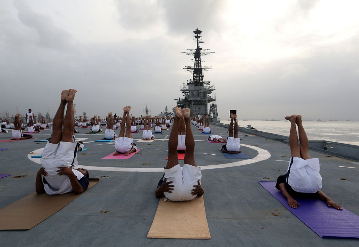 Members of the Indian Navy perform yoga on the flight deck of INS Viraat, an Indian Navy decommissioned aircraft carrier, during International Yoga Day in Mumbai, India, June 21, 2018. REUTERS/Francis
