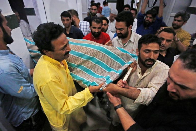 People carry the body of Syed Shujaat Bukhari, the editor of Rising Kashmir daily newspaper, who was killed by unidentified gunmen outside his office in Srinagar