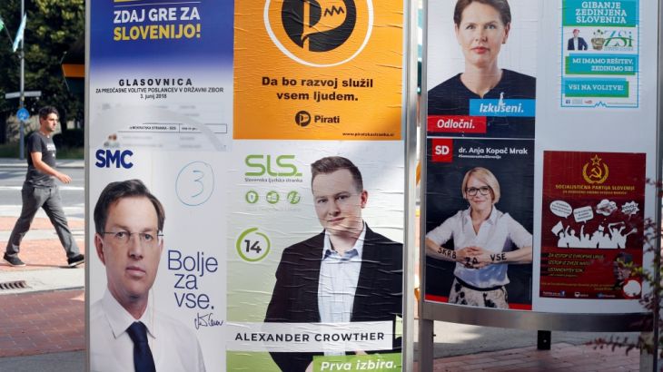 A man walks next to election posters for general elections in Ljubljana